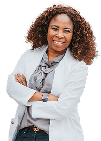 Dr. Chi Mba, DDS, smiling with her arms folded
